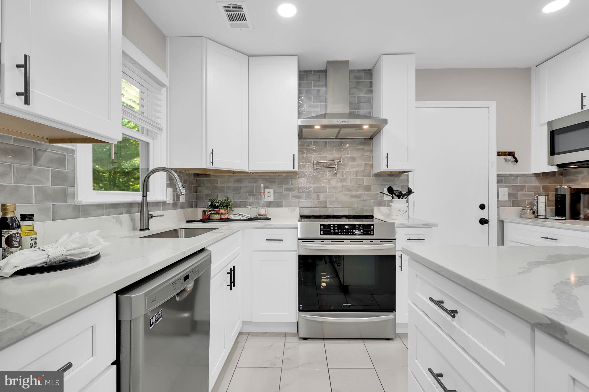 14901 Running Ridge Lane Silver Spring, MD 20906 - Photo 16 of 49 a kitchen with stainless steel appliances granite countertop a sink stove and cabinets