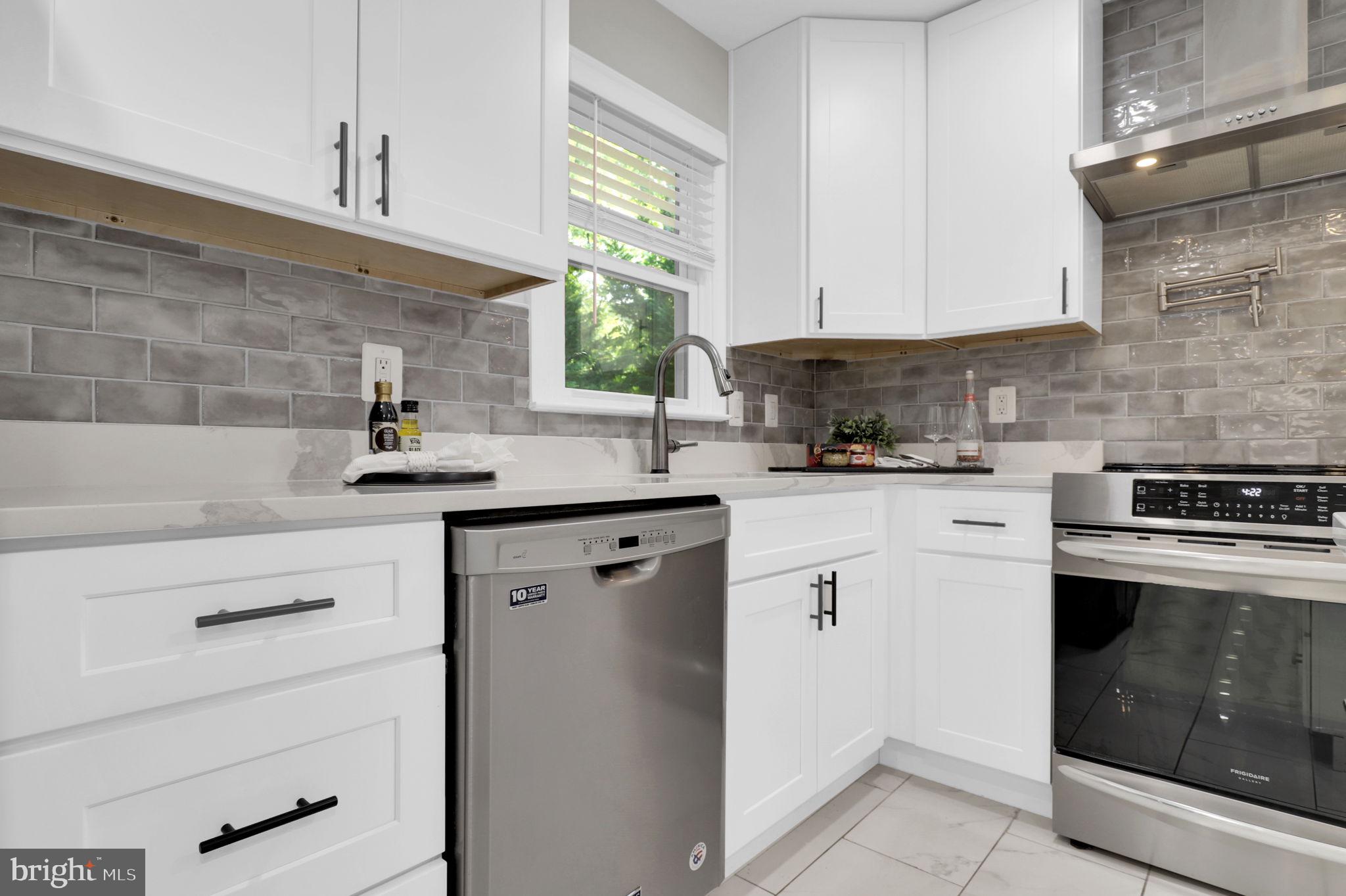 14901 Running Ridge Lane Silver Spring, MD 20906 - Photo 17 of 49 a kitchen with white cabinets sink and white appliances