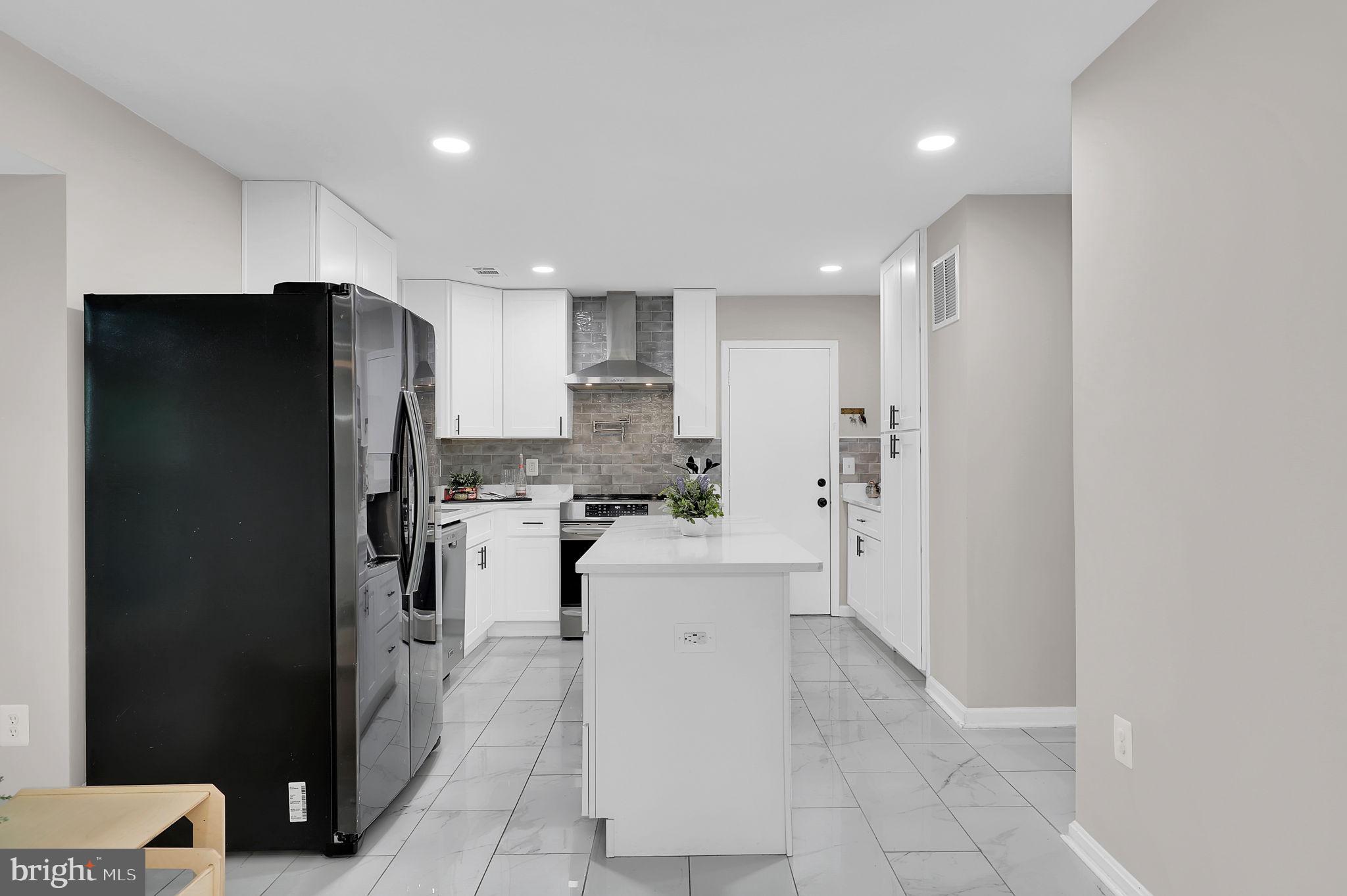 14901 Running Ridge Lane Silver Spring, MD 20906 - Photo 18 of 49 a kitchen with a refrigerator and a sink