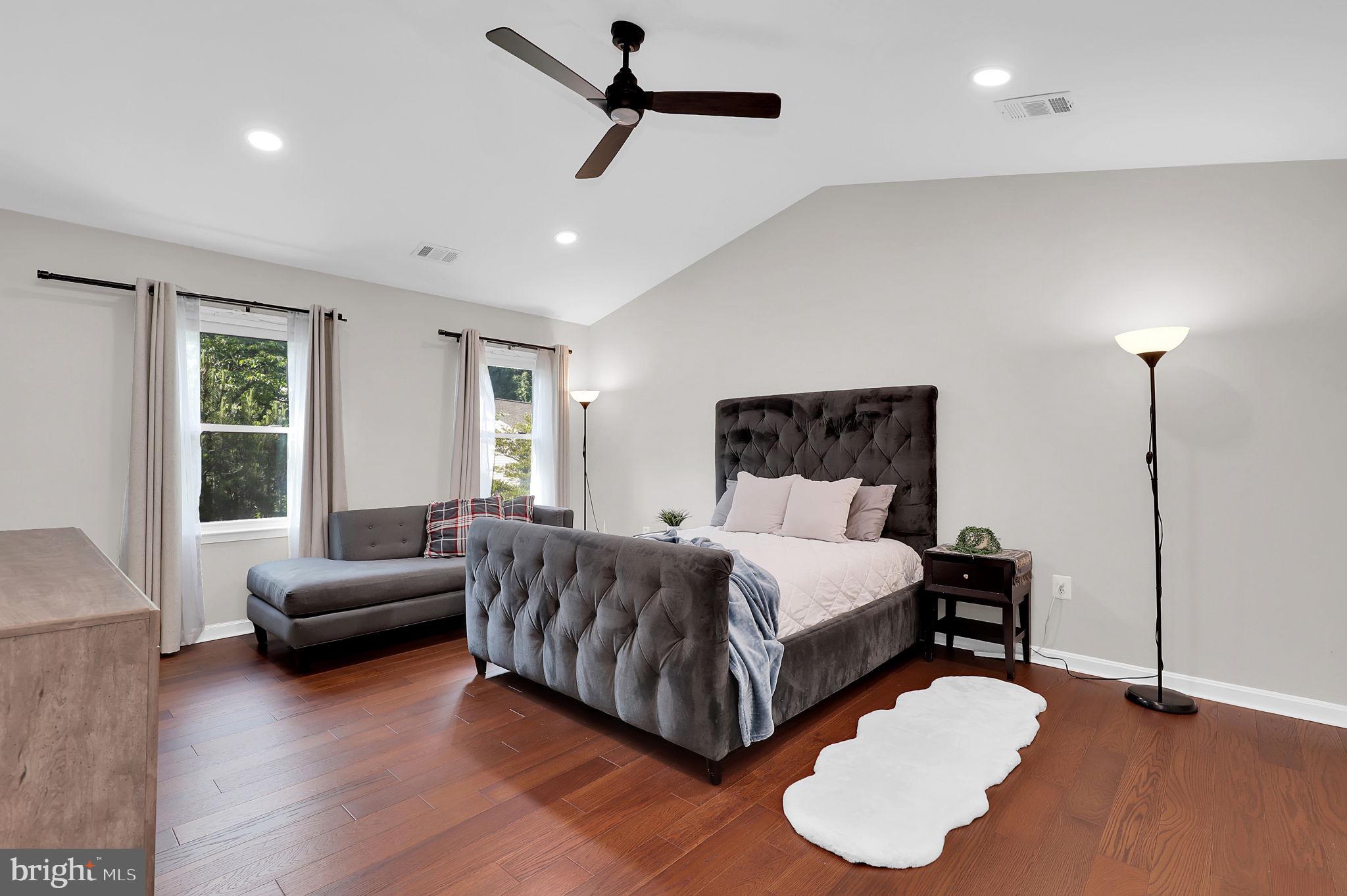 14901 Running Ridge Lane Silver Spring, MD 20906 - Photo 20 of 49 a spacious bedroom with a bed and a couch