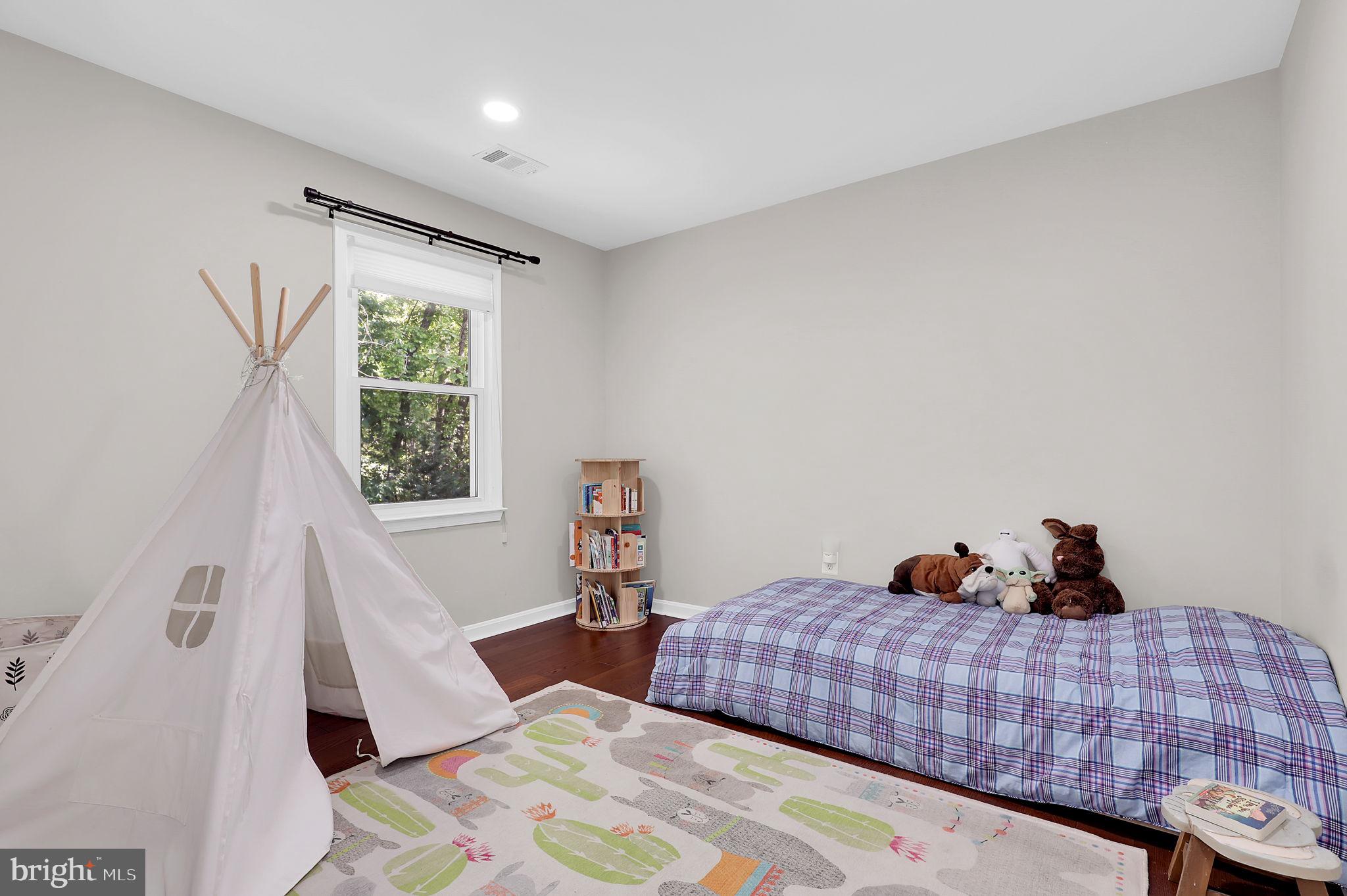 14901 Running Ridge Lane Silver Spring, MD 20906 - Photo 27 of 49 a bedroom with a bed and a window