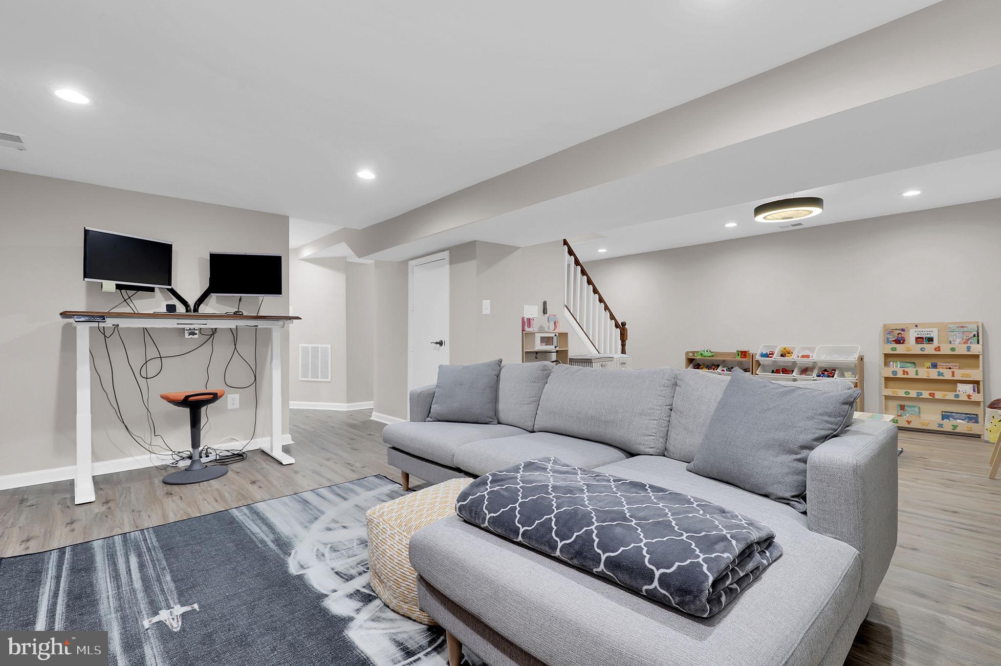 14901 Running Ridge Lane Silver Spring, MD 20906 - Photo 31 of 49 a living room with furniture and a flat screen tv