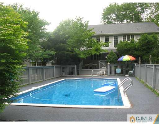 59 Henderson Road Kendall Park, NJ 08824 - Photo 11 of 12 a view of a swimming pool with a patio