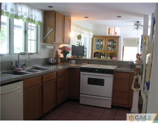 59 Henderson Road Kendall Park, NJ 08824 - Photo 3 of 12 a kitchen with stainless steel appliances granite countertop a sink stove and cabinets