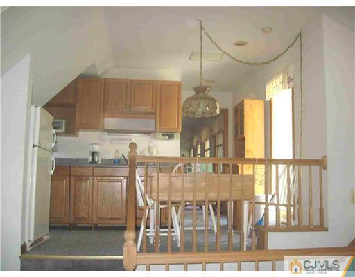 59 Henderson Road Kendall Park, NJ 08824 - Photo 7 of 12 a view of a dining room with furniture window and wooden floor