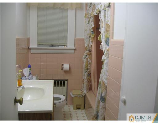 59 Henderson Road Kendall Park, NJ 08824 - Photo 10 of 12 a bathroom with a sink and mirror