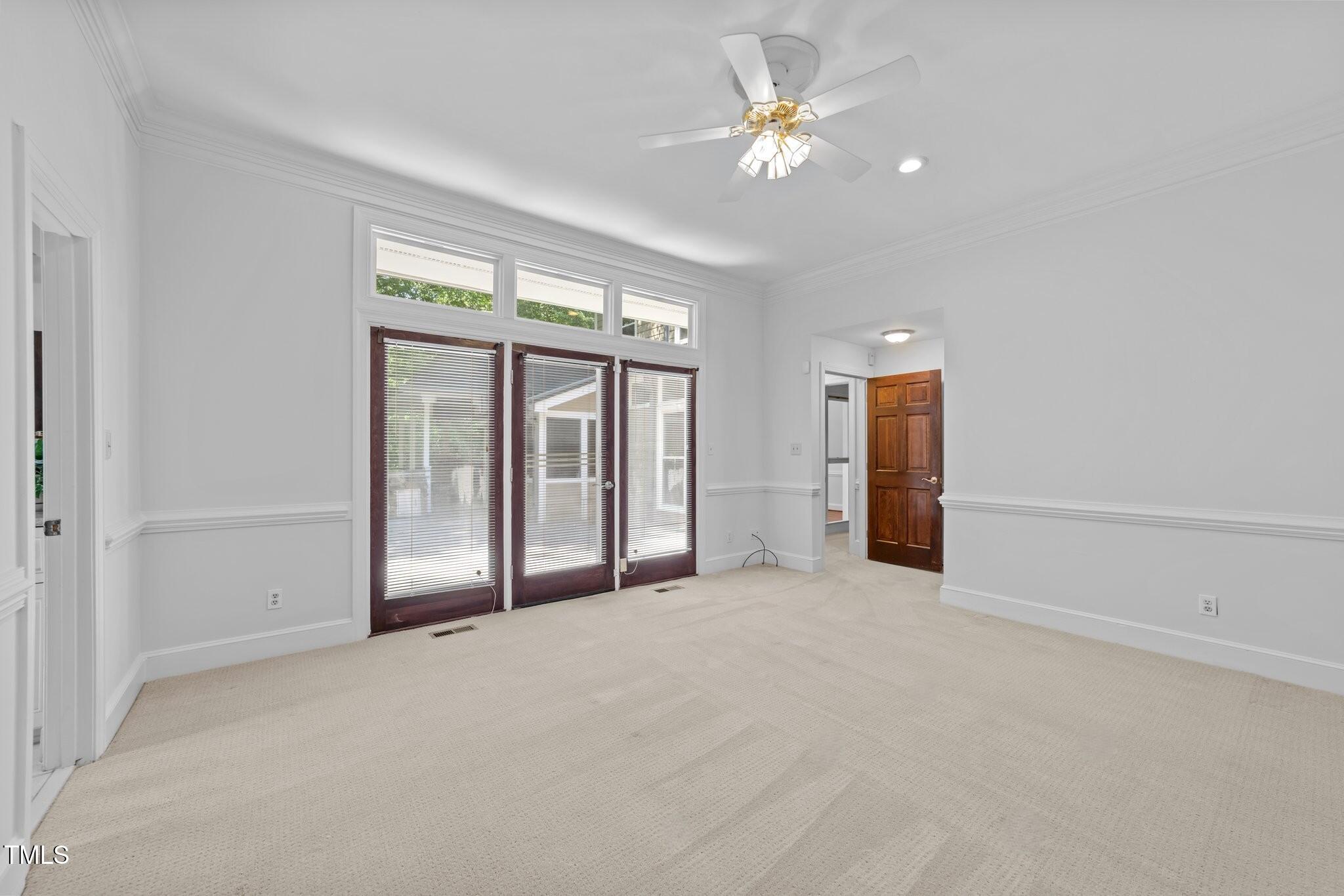 11425 Horseman's Trail Raleigh, NC 27613 - Photo 20 of 64 an empty room with chandelier fan and windows