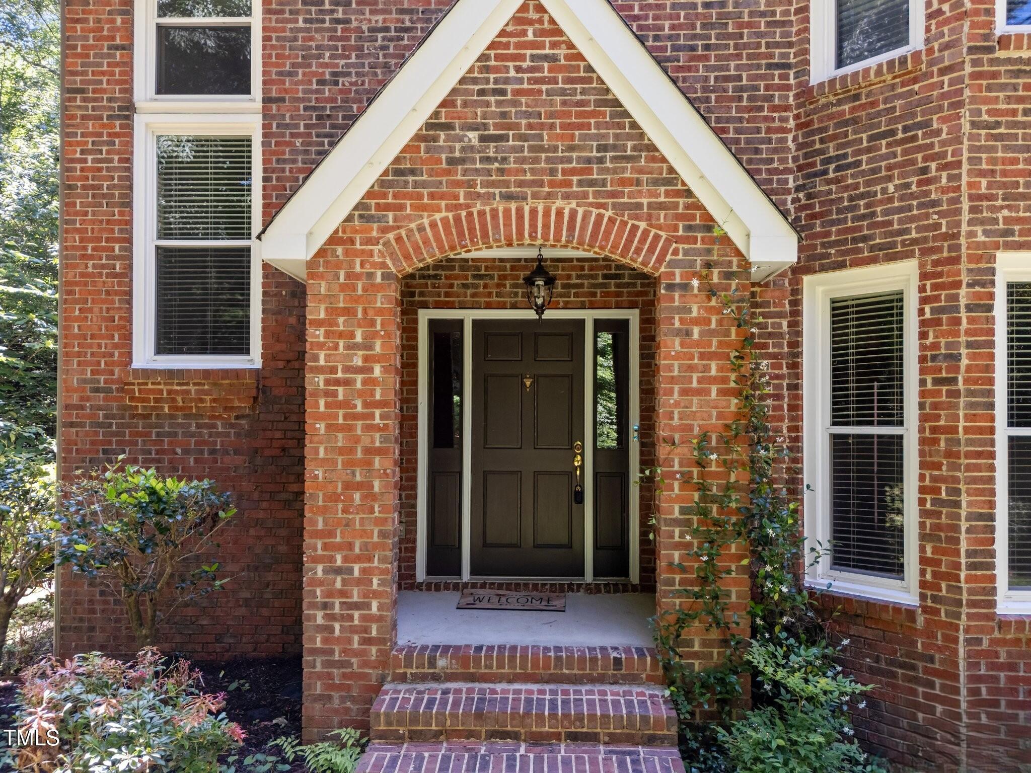 11425 Horseman's Trail Raleigh, NC 27613 - Photo 2 of 64 a front view of a house with a porch