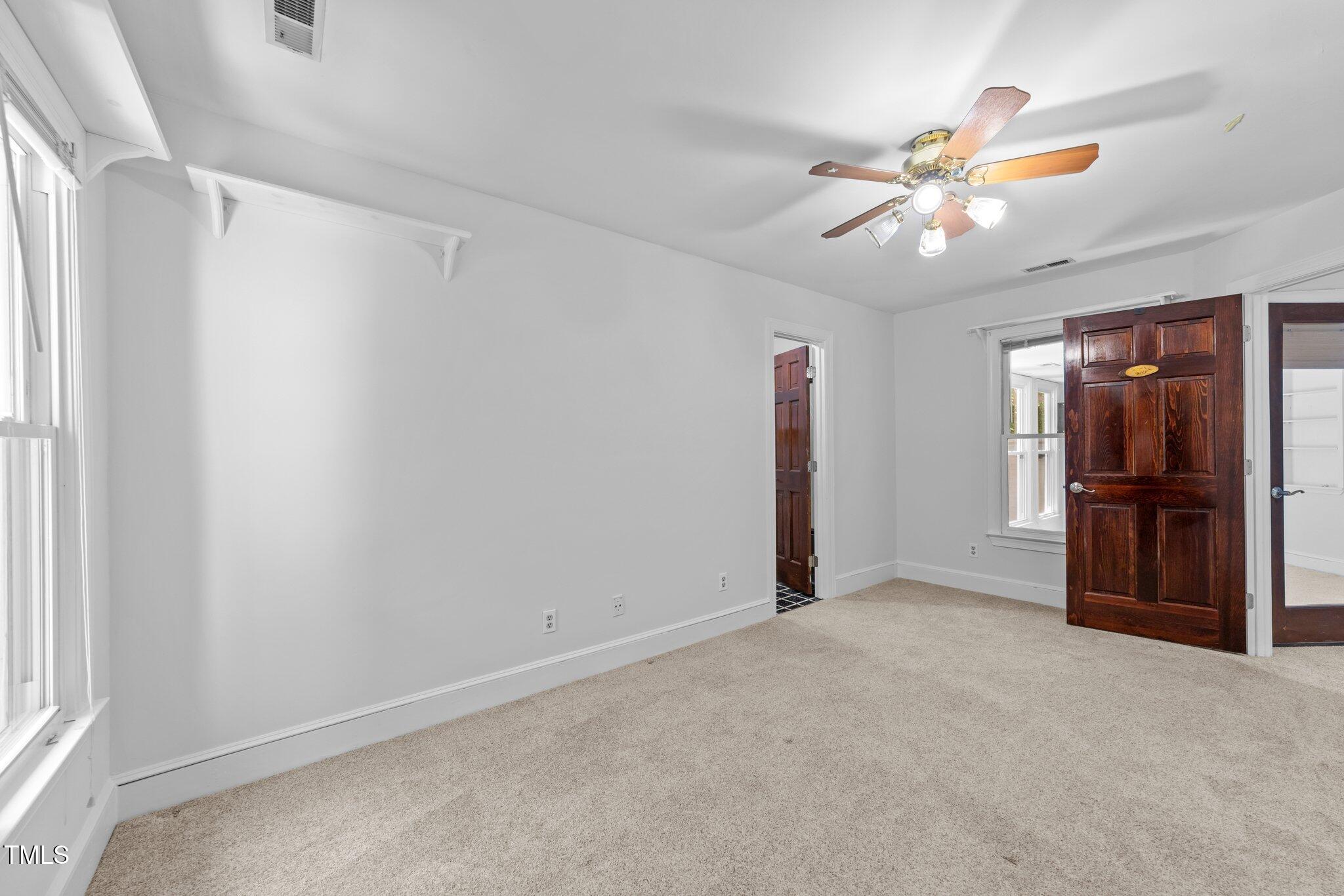 11425 Horseman's Trail Raleigh, NC 27613 - Photo 30 of 64 a view of a livingroom with a ceiling fan and window