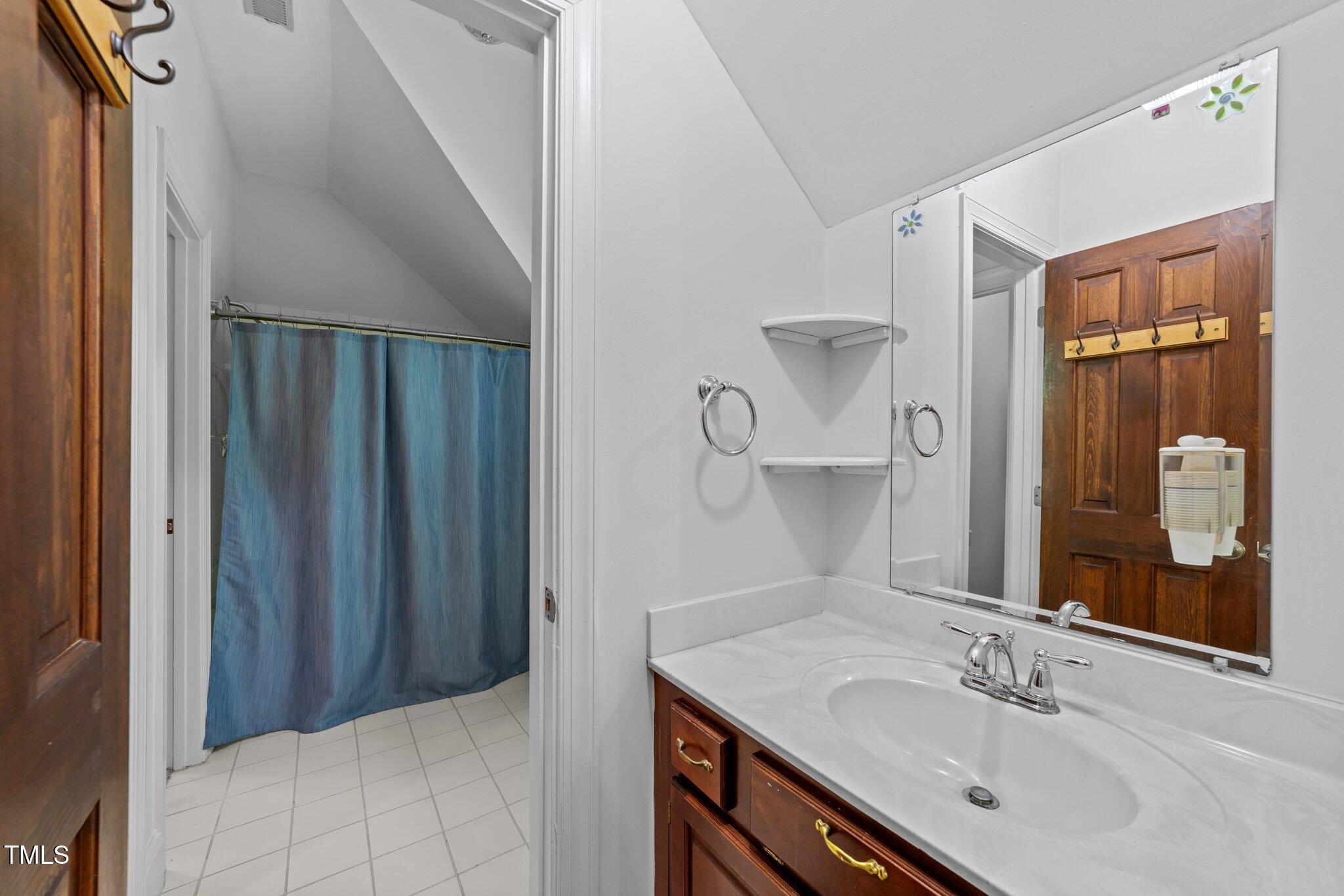 11425 Horseman's Trail Raleigh, NC 27613 - Photo 35 of 64 a bathroom with a sink vanity granite and a mirror