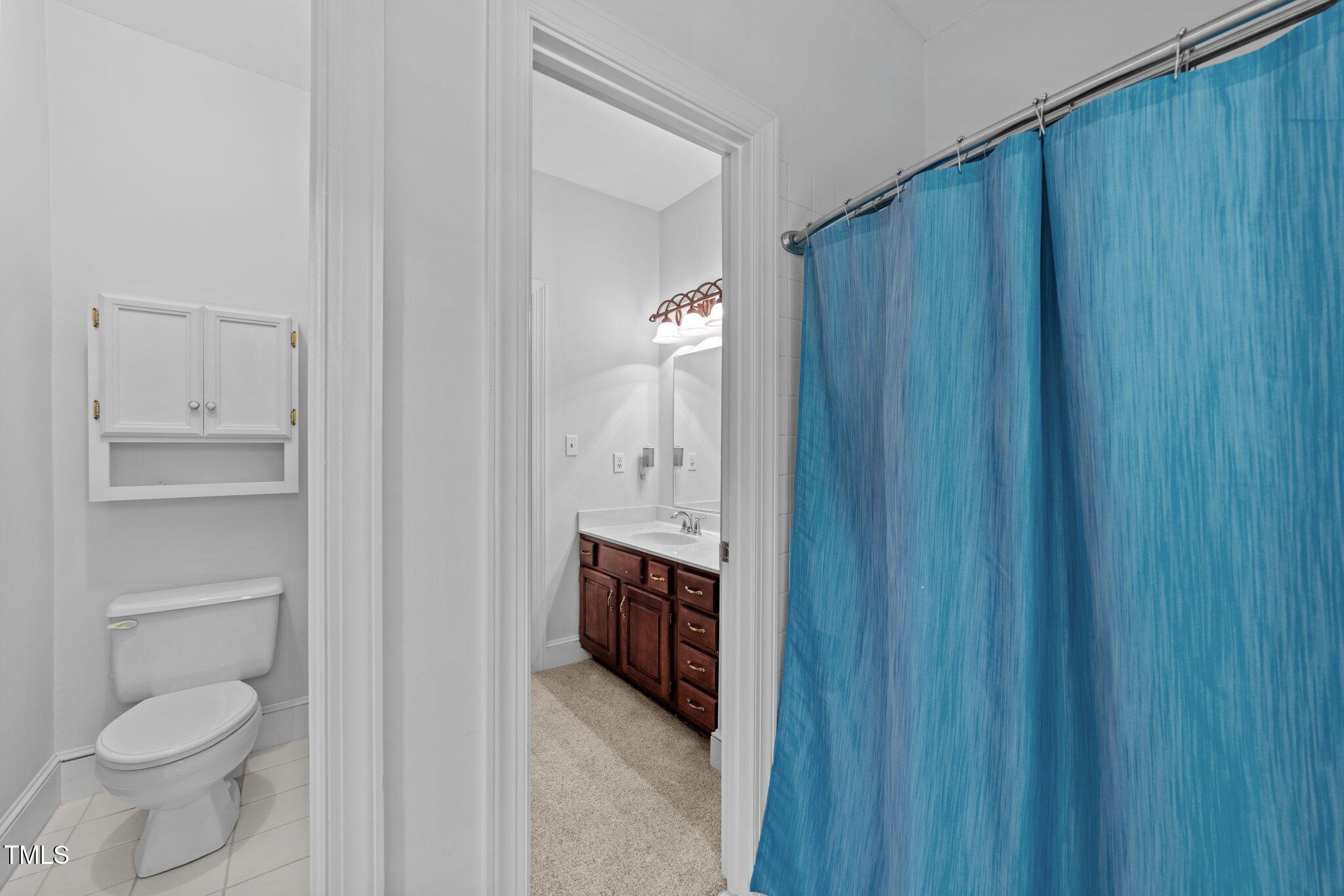 11425 Horseman's Trail Raleigh, NC 27613 - Photo 36 of 64 a bathroom with a toilet a sink and mirror