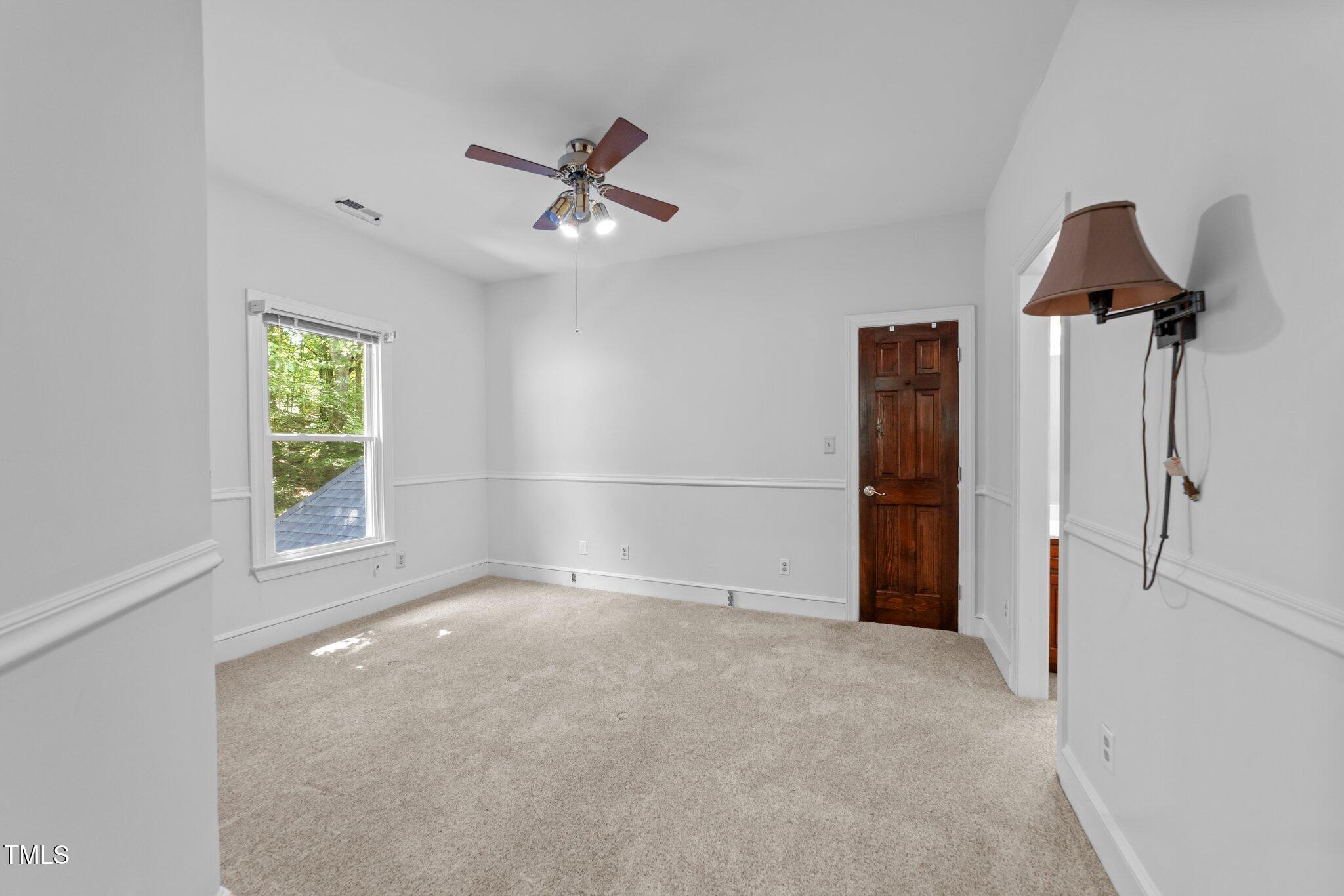 11425 Horseman's Trail Raleigh, NC 27613 - Photo 38 of 64 a view of empty room with windows and ceiling fan