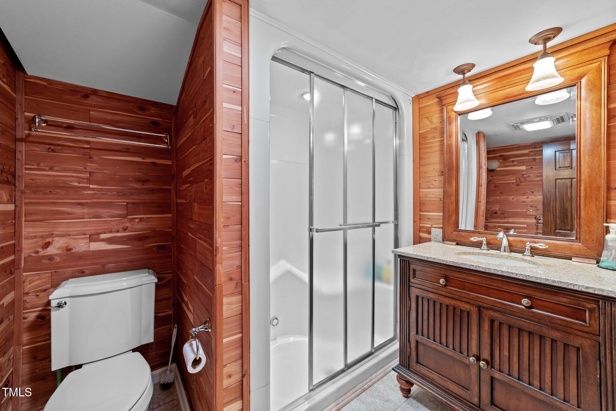 11425 Horseman's Trail Raleigh, NC 27613 - Photo 40 of 64 a bathroom with a toilet a sink and mirror