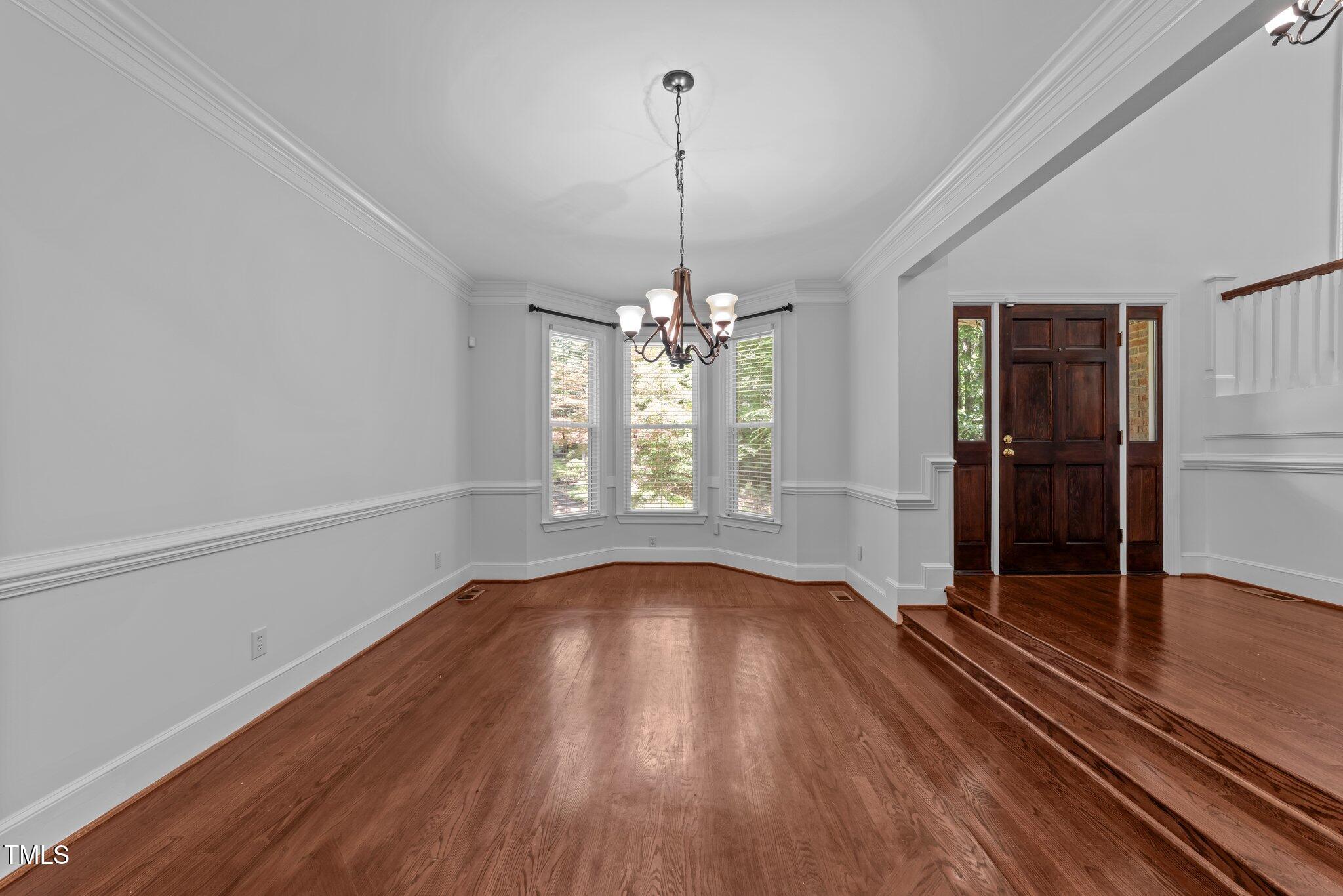 11425 Horseman's Trail Raleigh, NC 27613 - Photo 4 of 64 a view of a room with wooden floor staircase and a ceiling fan