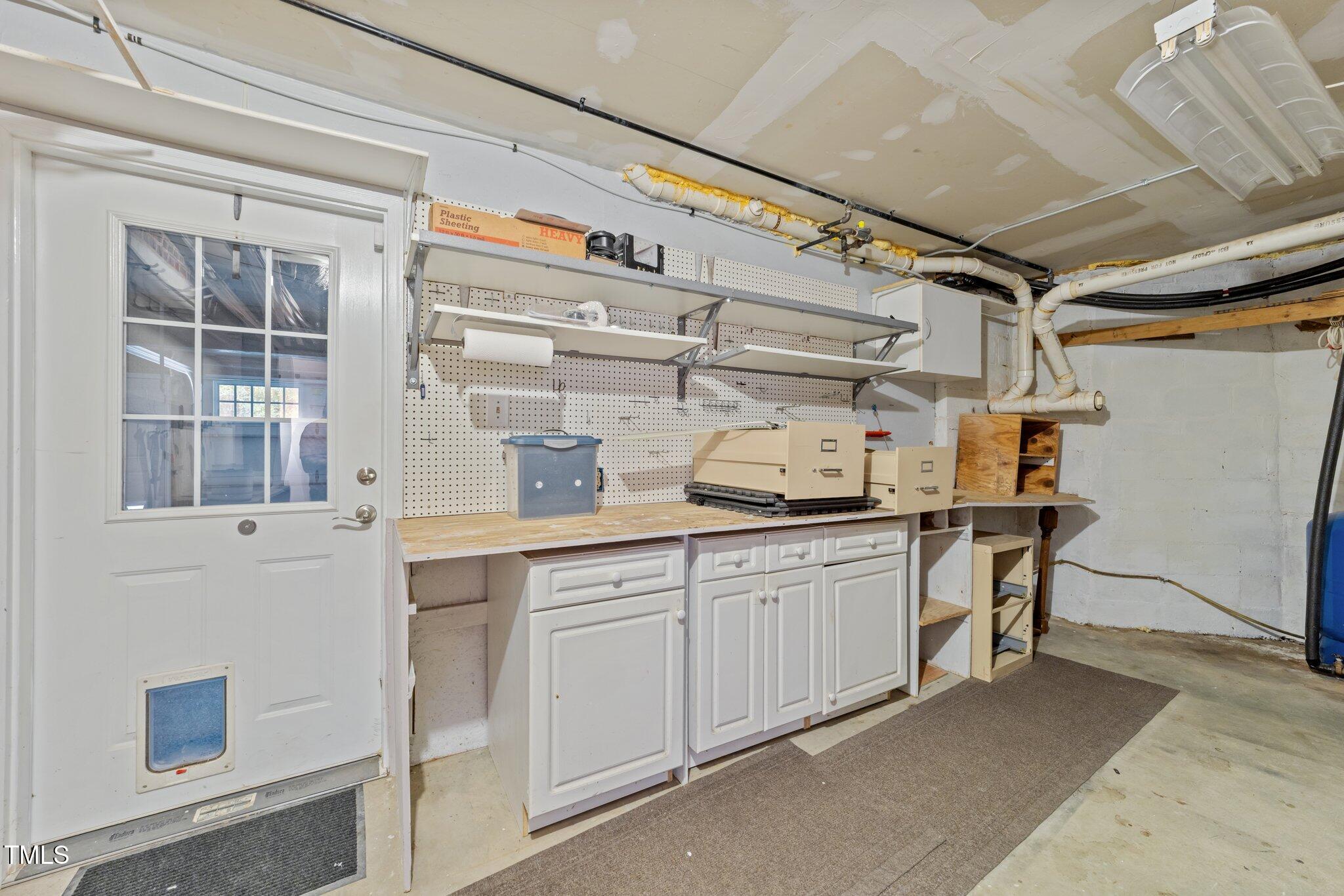 11425 Horseman's Trail Raleigh, NC 27613 - Photo 47 of 64 a kitchen with white cabinets and sink