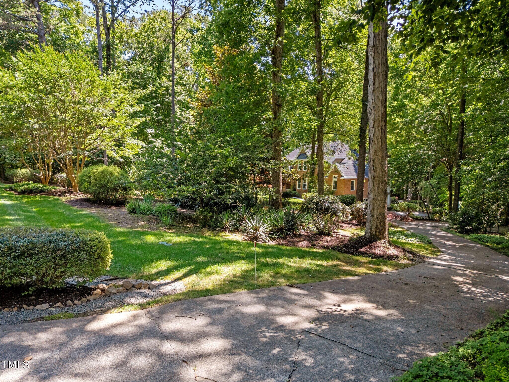 11425 Horseman's Trail Raleigh, NC 27613 - Photo 58 of 64 a view of a tree in front of a house