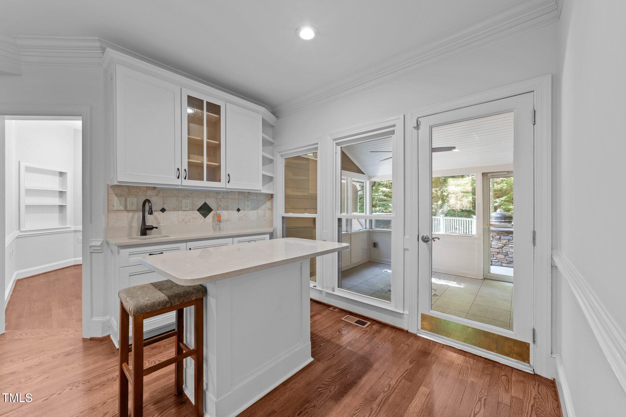 11425 Horseman's Trail Raleigh, NC 27613 - Photo 10 of 64 a kitchen with kitchen island a table and chairs in it
