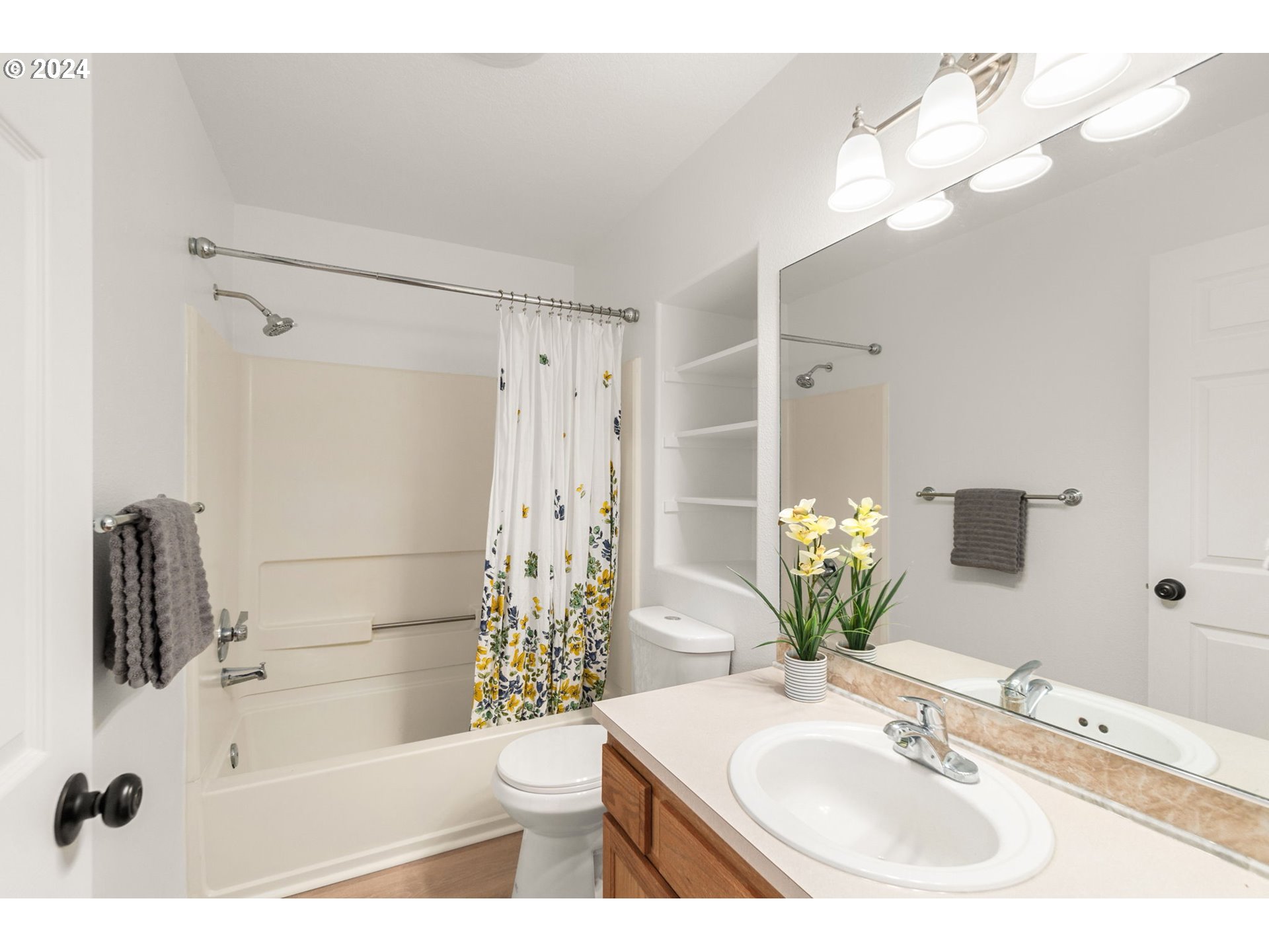 2501 Northwest 1st Drive Gresham, OR 97030 - Photo 21 of 27 a bathroom with a sink a toilet a mirror a vanity and shower