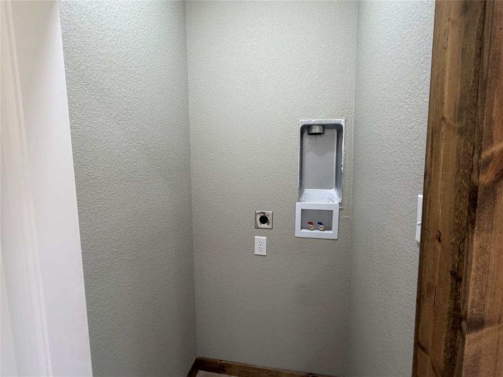 1040 Rays Way Weatherford, TX 76085 - Photo 14 of 23 Dedicated laundry area featuring a recessed hookup box and stacked Washer & Dryer