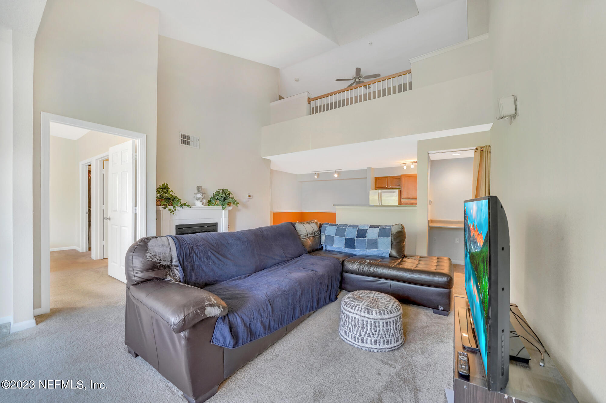8550 Touchton Road, Unit 933 Jacksonville, FL 32216 - Photo 8 of 22 a living room with furniture and a flat screen tv