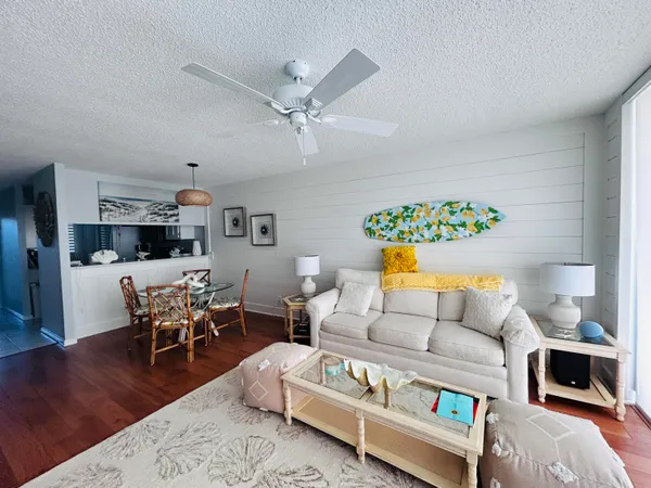 a living room with furniture and a wooden floor