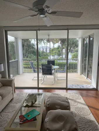 a living room with couch and a floor to ceiling window