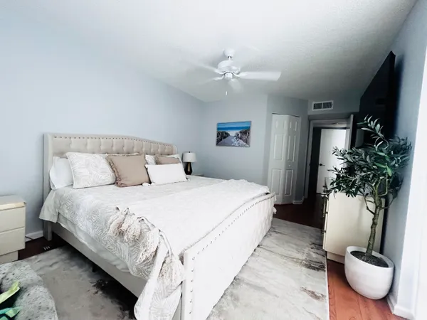 a bedroom with bed and a potted plant