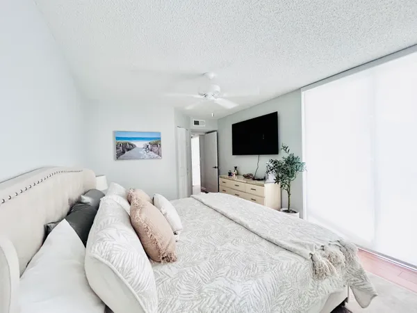 a bedroom with a bed and a flat screen tv