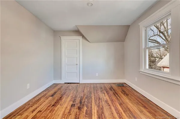 a view of room with window and wooden floor