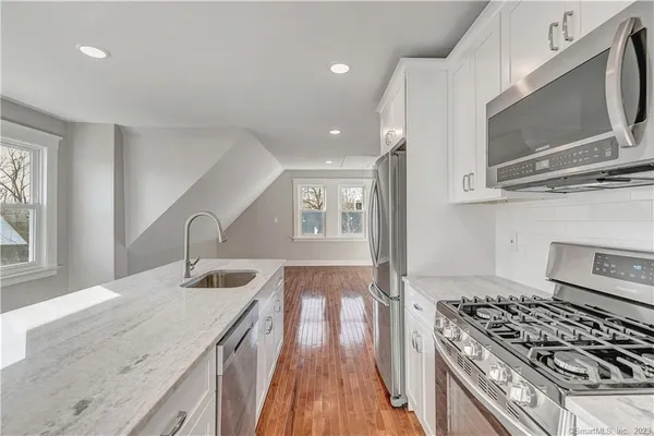 a kitchen with granite countertop a stove and a sink