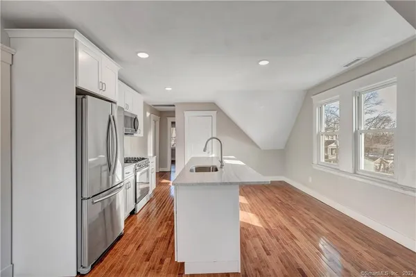 a hallway with windows and chandelier