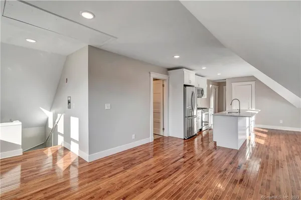 a view of empty room with wooden floor
