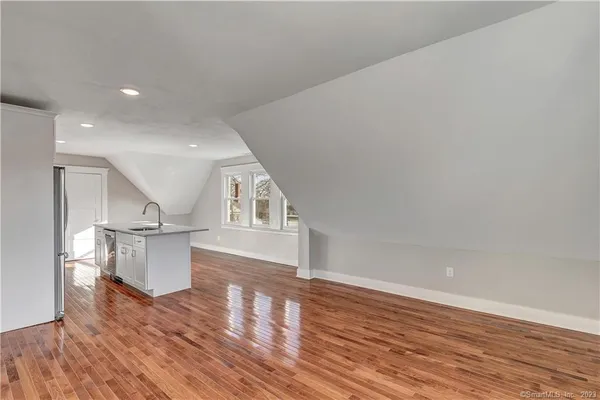 a view of a kitchen with furniture and wooden floor