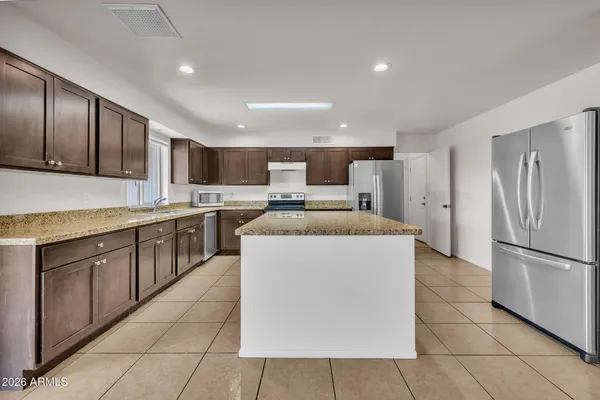 a view of a kitchen with furniture and an empty room