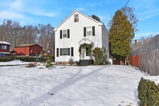 a view of a house with a yard and garage