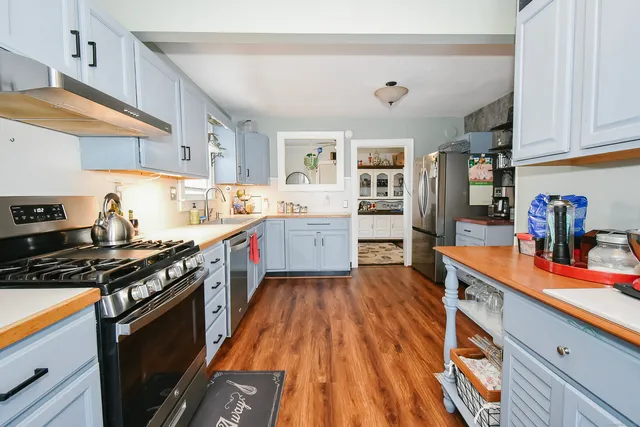 a kitchen with stainless steel appliances granite countertop a stove and a sink