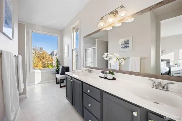 a bathroom with a sink double vanity granite and a mirror