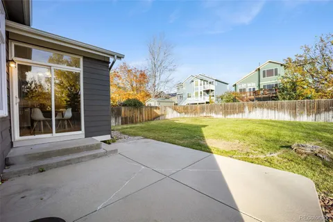 a view of a house with a yard and sitting area