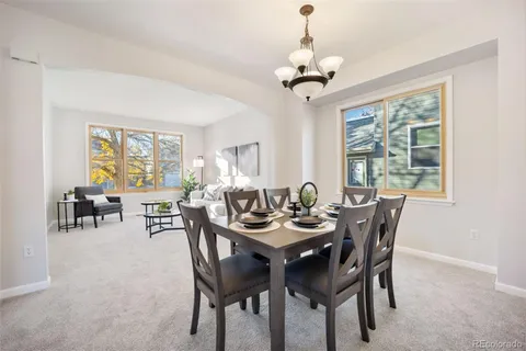 a dining room with furniture a window and a chandelier