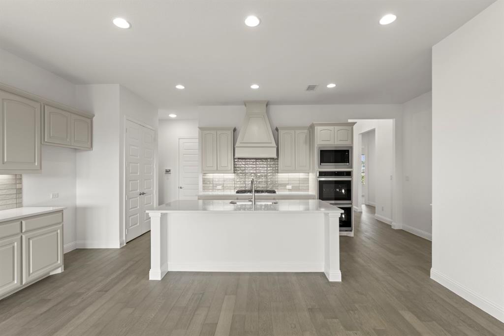 1442 Canadian Lane Van Alstyne, TX 75495 - Photo 5 of 27 a view of kitchen with stainless steel appliances granite countertop cabinets and wooden floor