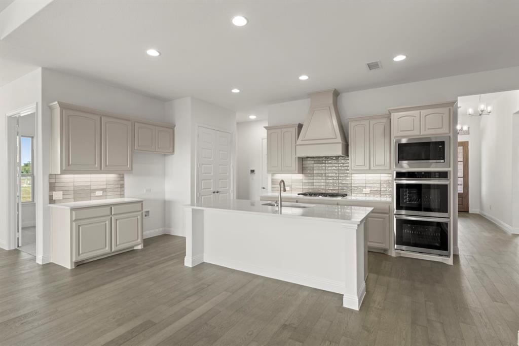 1442 Canadian Lane Van Alstyne, TX 75495 - Photo 6 of 27 a kitchen with a sink stainless steel appliances and cabinets