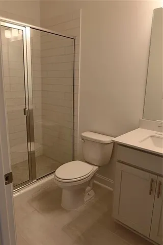 a bathroom with a toilet and a shower