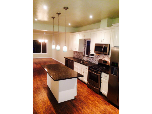 369 Pacific Avenue Pacifica, CA 94044 - Photo 3 of 6 a kitchen with stainless steel appliances granite countertop a sink and a stove