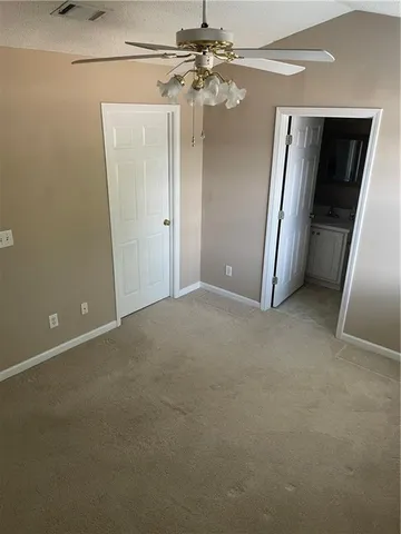 en empty room with windows and entrance