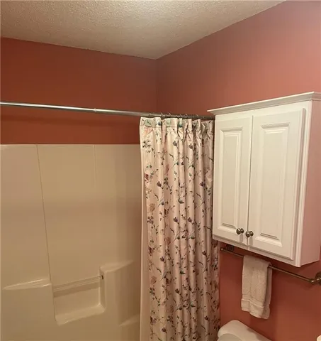 a view of a livingroom with an empty space and a window