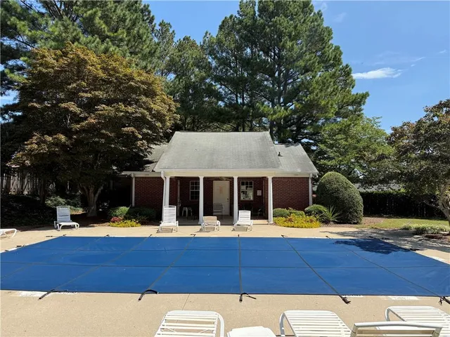 a view of swimming pool with deck and a garden