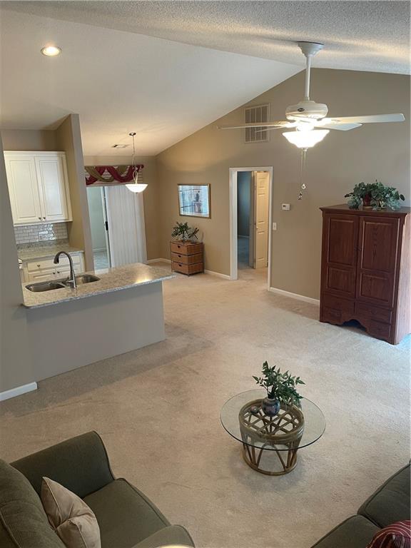 2849 Florence Drive Gainesville, GA 30504 - Photo 3 of 22 a living room with furniture a chandelier and a view of kitchen