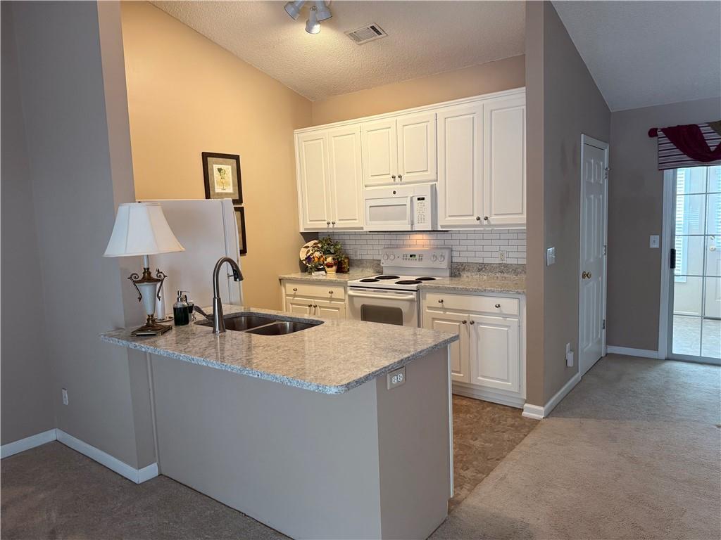 2849 Florence Drive Gainesville, GA 30504 - Photo 8 of 22 a kitchen with stainless steel appliances granite countertop a sink stove and refrigerator