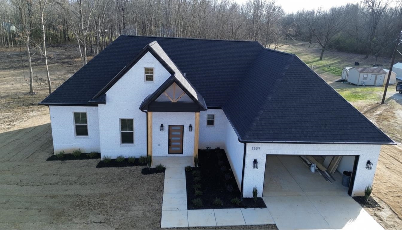 View of front of home featuring concrete driveway, a garage, and a shingled roof