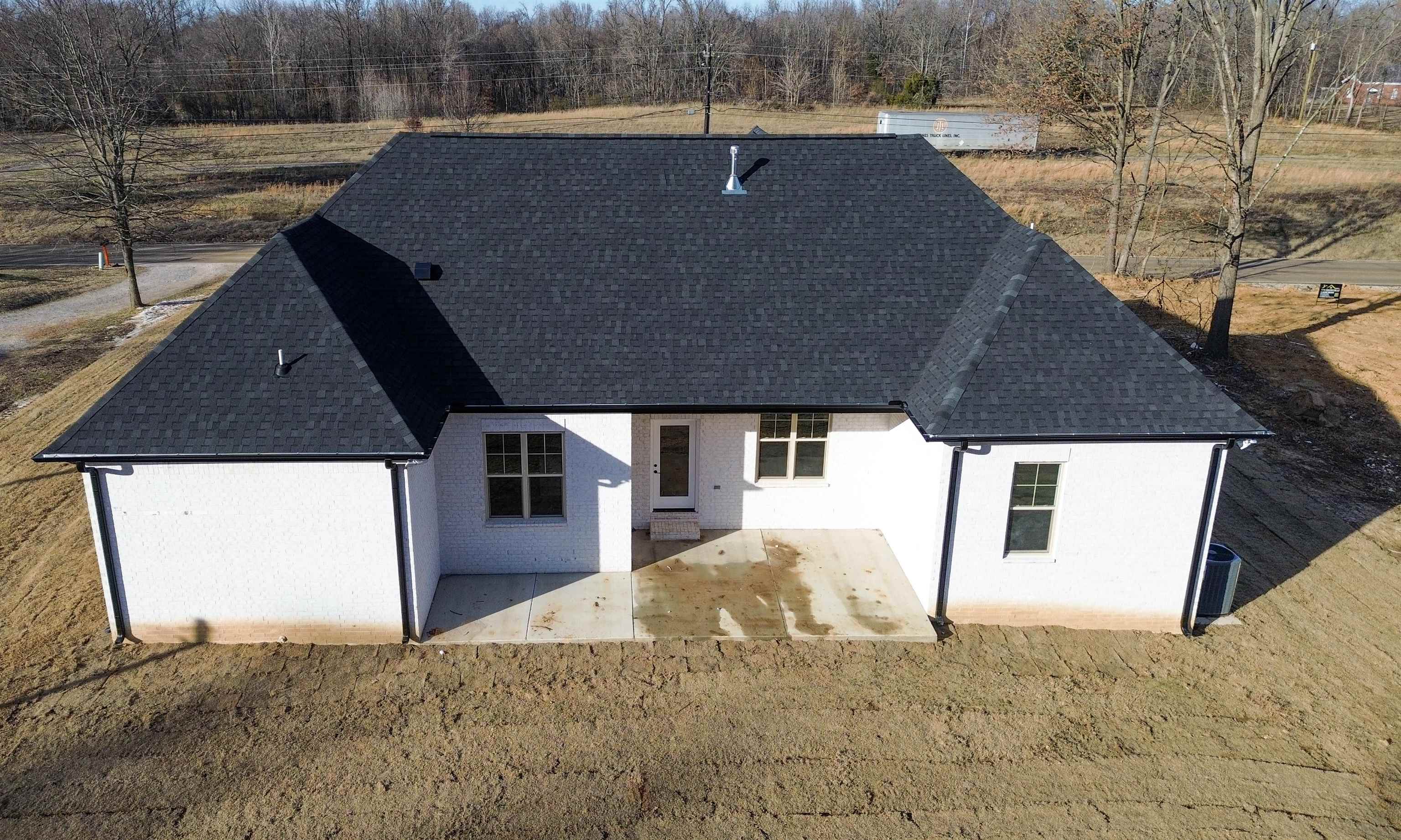 2939 Brighton-Clopton Road Brighton, TN 38011 - Photo 5 of 23 Back of property with a patio area, roof with shingles, and stucco siding